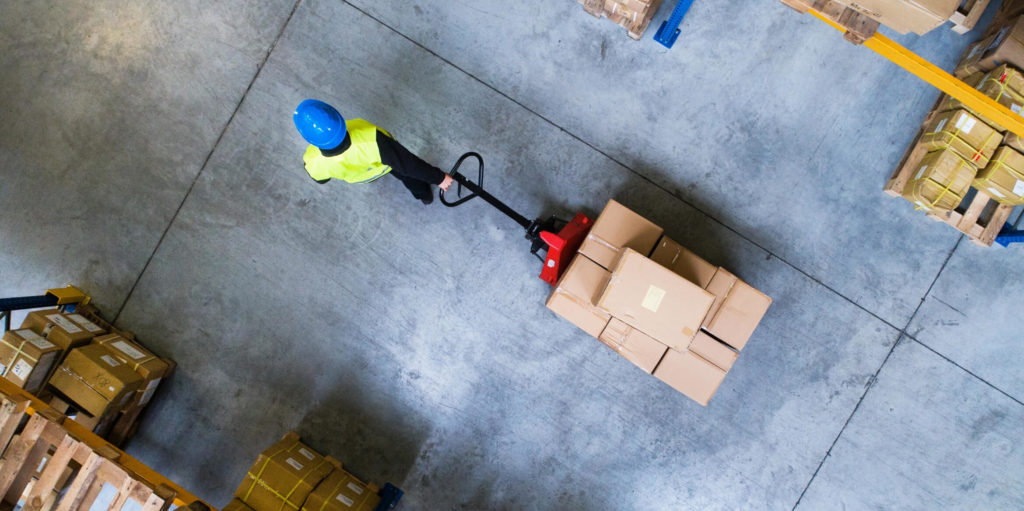 person pulling warehouse trolley